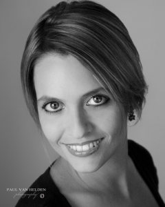 Female headshot in black and white, natural window lighting was used.